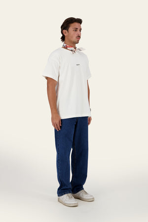 Model wearing WHY Tee white oversized t-shirt with blue denim pants