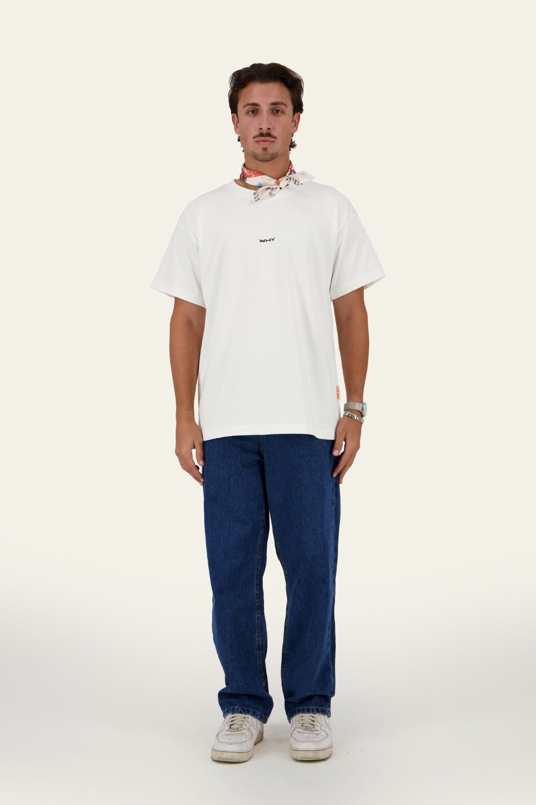 Model wearing WHY Tee white oversized t-shirt with blue denim pants