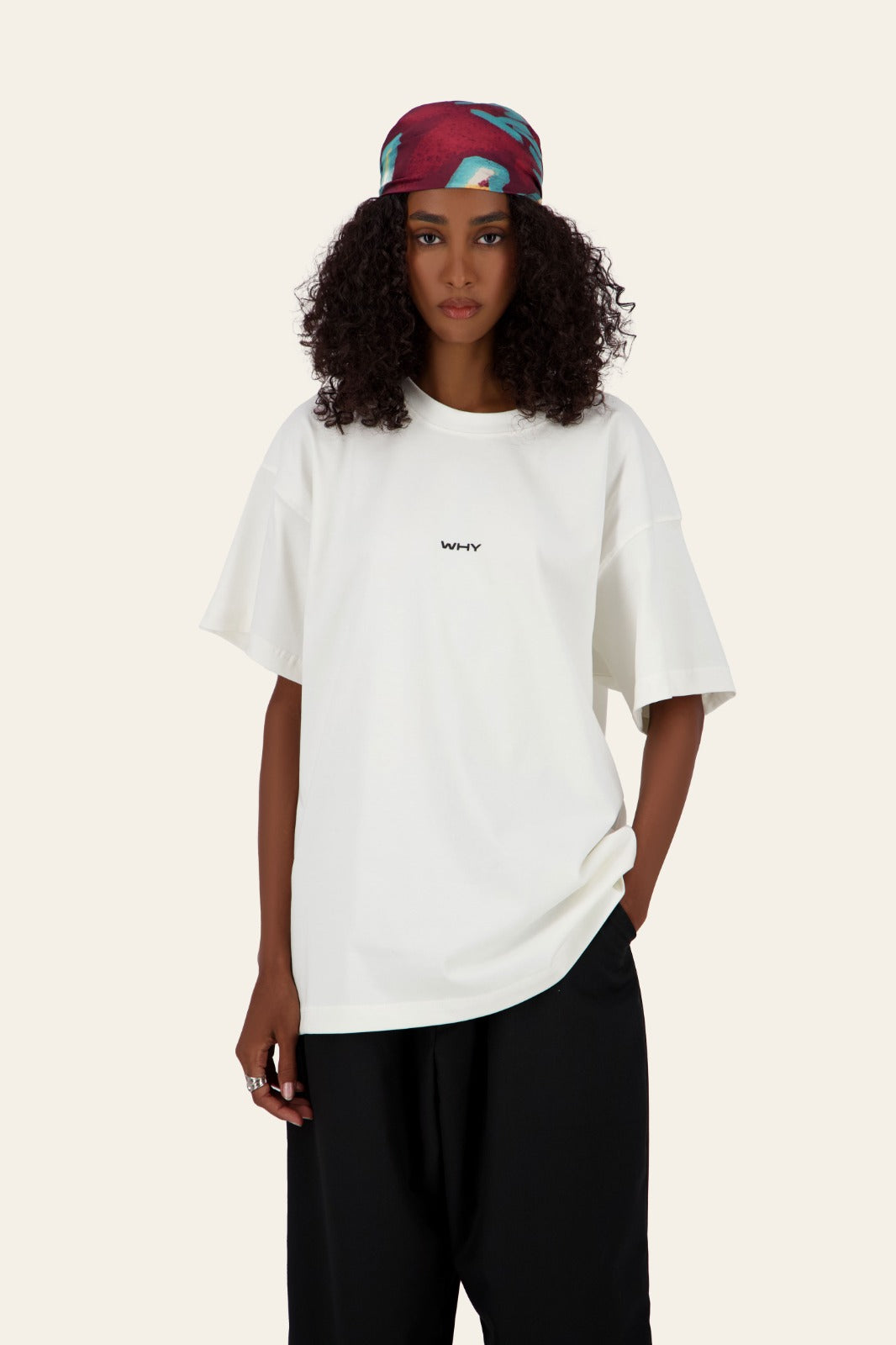 Model wearing WHY Tee white oversized t-shirt with blue denim pants