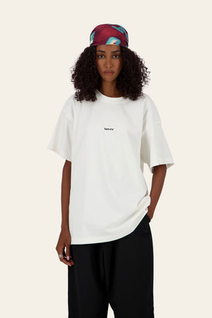 Model wearing WHY Tee white oversized t-shirt with blue denim pants