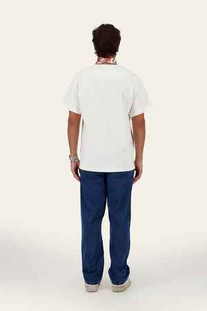 Model wearing WHY Tee white oversized t-shirt with blue denim pants